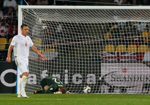England goalkeeper Robert Green, center, reacts on the ground after United States' Clint Dempsey, not seen, scored a goal during the World Cup group C soccer match between England and the United States at Royal Bafokeng Stadium in Rustenburg, South Africa, on Saturday, June 12, 2010. (AP Photo/Eugene Hoshiko)